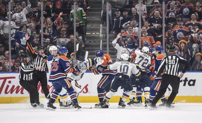 St. Louis Blues and Edmonton Oilers players rough it up during first period NHL action in Edmonton on Wednesday, April 9, 2025. (Jason Franson/The Canadian Press via AP)