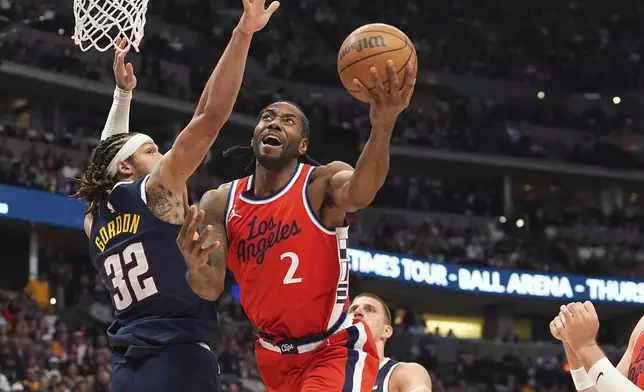 Los Angeles Clippers forward Kawhi Leonard (2) drives past Denver Nuggets forward Aaron Gordon (32) in the second half of Game 2 of a first-round NBA playoff series Monday, April 21, 2025, in Denver. (AP Photo/David Zalubowski)