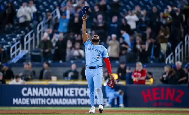 Toronto Blue Jays first base Vladimir Guerrero Jr. (27) celebrates a win over the Washington Nationals following MLB baseball action in Toronto, Monday, March 31, 2025. (Thomas Skrlj/The Canadian Press via AP)