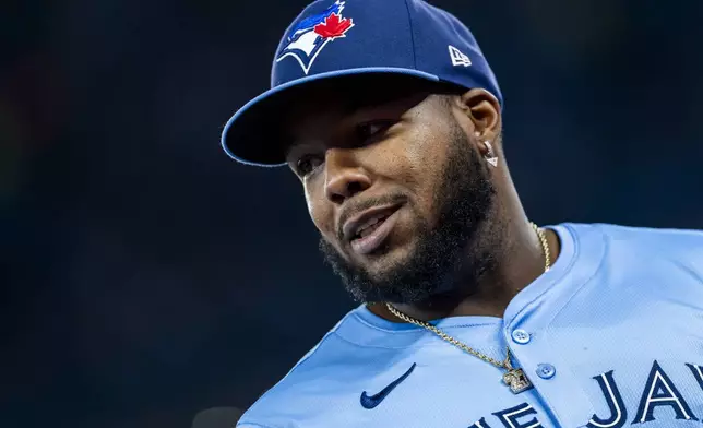 Toronto Blue Jays first base Vladimir Guerrero Jr. (27) looks on prior to MLB baseball action against the Washington Nationals, in Toronto, Monday, March 31, 2025. (Thomas Skrlj/The Canadian Press via AP)
