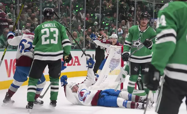 Colorado Avalanche right wing Logan O'Connor, bottom, reacts after scoring a goal against the Dallas Stars during the second period in Game 2 of a first-round NHL hockey playoff series Monday, April 21, 2025, in Dallas. (AP Photo/Julio Cortez)