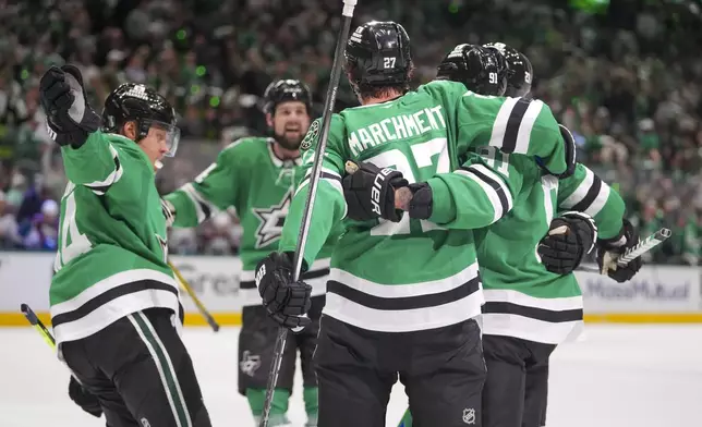 Dallas Stars players celebrate a power play goal by center Tyler Seguin, second from right, during the first period in Game 2 of a first-round NHL hockey playoff series against the Colorado Avalanche Monday, April 21, 2025, in Dallas. (AP Photo/Julio Cortez)