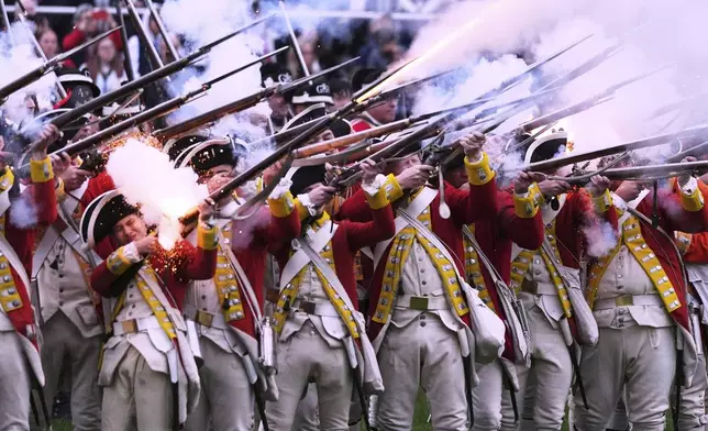 British Regulars fire on New England colonial militia, also known as a Minutemen, during a reenactment celebration of the 250th anniversary of the Battle of Lexington and start of the American Revolution, Saturday, April 19, 2025, in Lexington, Mass. (AP Photo/Charles Krupa)