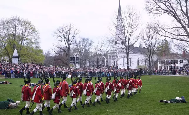 British Regulars march past fallen New England colonial militia, also known as a Minuteman, during a reenactment celebration of the 250th anniversary of the Battle of Lexington and start of the American Revolution, Saturday, April 19, 2025, in Lexington, Mass. (AP Photo/Charles Krupa)