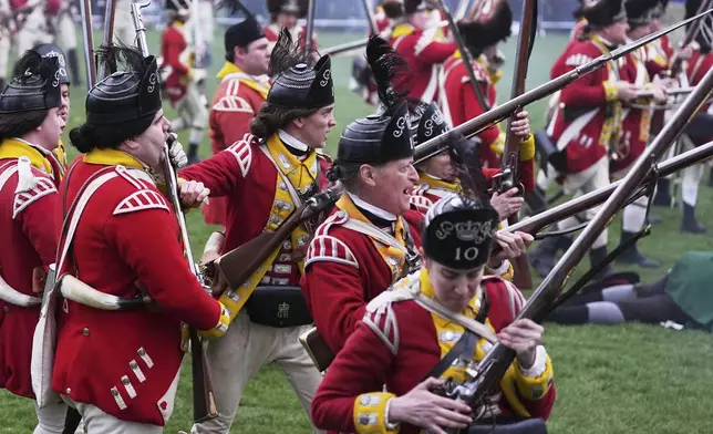 British Regulars fire on New England colonial militia, also known as a Minuteman, during a reenactment celebration of the 250th anniversary of the Battle of Lexington and start of the American Revolution, Saturday, April 19, 2025, in Lexington, Mass. (AP Photo/Charles Krupa)