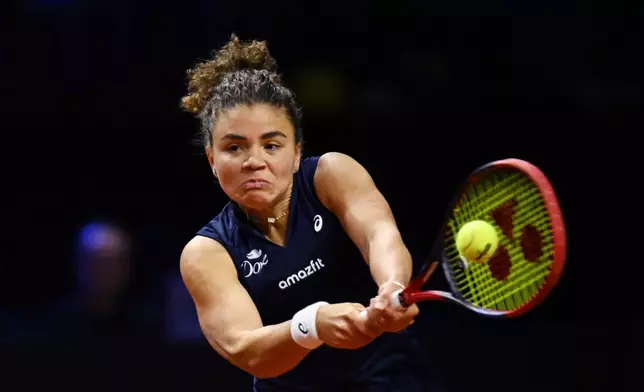 Jasmine Paolini of Italy in action against Aryna Sabalenka of Belarus during the women's singles semi-final tennis match of the WTA tour, in Stuttgart, Germany, Sunday, April 20, 2025. (Marijan Murat/dpa via AP)