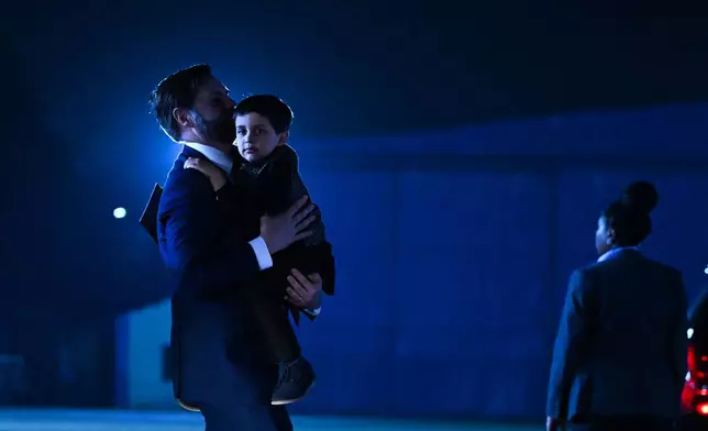 U.S. Vice President JD Vance carries his son Vivek across the tarmac to board Air Force Two en route to Jaipur, India, after spending the day in New Delhi, Monday, April 21, 2025. (Kenny Holston/The New York Times via AP, Pool)