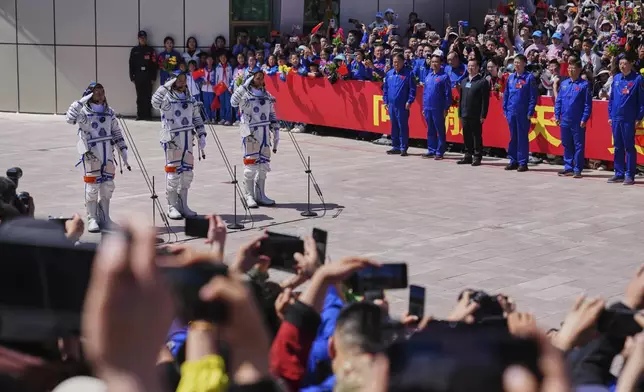 Chinese astronauts for the Shenzhou 20 mission, from right, Chen Zhongrui, Chen Dong and Wang Jie salute as they attend a send-off ceremony for their manned space mission at the Jiuquan Satellite Launch Center in northwestern China, Thursday, April 24, 2025. (AP Photo/Andy Wong)