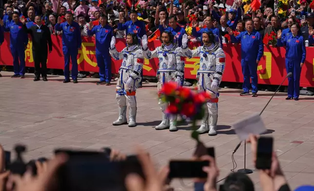 Chinese astronauts for the Shenzhou 20 mission, from right, Chen Zhongrui, Chen Dong and Wang Jie wave as they attend a send-off ceremony for their manned space mission at the Jiuquan Satellite Launch Center in northwestern China, Thursday, April 24, 2025. (AP Photo/Andy Wong)