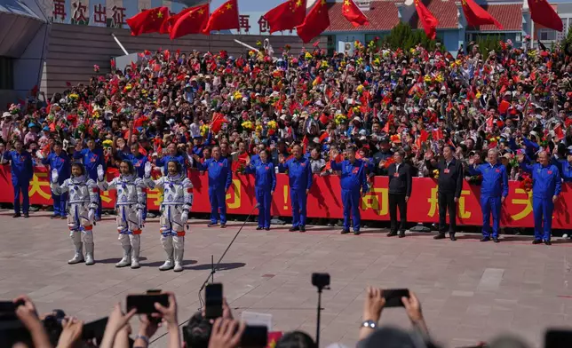 Chinese astronauts for the Shenzhou 20 mission, from right, Chen Zhongrui, Chen Dong and Wang Jie wave as they attend a send-off ceremony for their manned space mission at the Jiuquan Satellite Launch Center in northwestern China, Thursday, April 24, 2025. (AP Photo/Andy Wong)