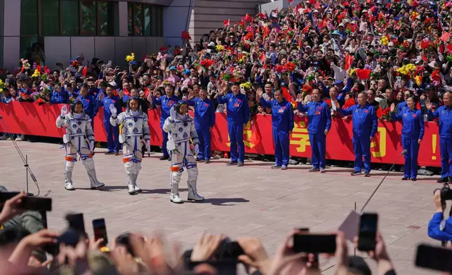 Chinese astronauts for the Shenzhou 20 mission, from right, Chen Zhongrui, Chen Dong and Wang Jie wave as they attend a send-off ceremony for their manned space mission at the Jiuquan Satellite Launch Center in northwestern China, Thursday, April 24, 2025. (AP Photo/Andy Wong)