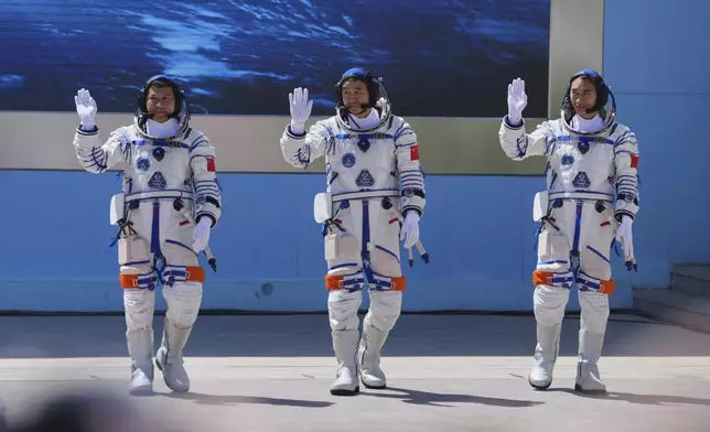 Chinese astronauts for the Shenzhou 20 mission, from right, Chen Zhongrui, Chen Dong and Wang Jie wave as they attend a send-off ceremony for their manned space mission at the Jiuquan Satellite Launch Center in northwestern China, Thursday, April 24, 2025. (AP Photo/Andy Wong)