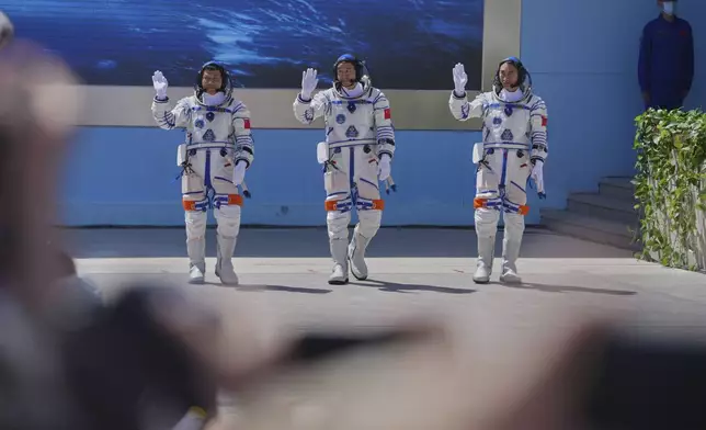 Chinese astronauts for the Shenzhou 20 mission, from right, Chen Zhongrui, Chen Dong and Wang Jie wave as they attend a send-off ceremony for their manned space mission at the Jiuquan Satellite Launch Center in northwestern China, Thursday, April 24, 2025. (AP Photo/Andy Wong)