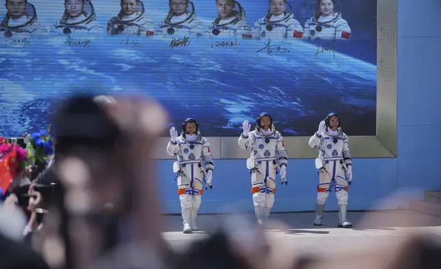 Chinese astronauts for the Shenzhou 20 mission, from right, Chen Zhongrui, Chen Dong and Wang Jie wave as they attend a send-off ceremony for their manned space mission at the Jiuquan Satellite Launch Center in northwestern China, Thursday, April 24, 2025. (AP Photo/Andy Wong)