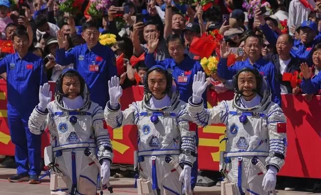 Chinese astronauts for the Shenzhou 20 mission, from right, Chen Zhongrui, Chen Dong and Wang Jie wave as they attend a send-off ceremony for their manned space mission at the Jiuquan Satellite Launch Center in northwestern China, Thursday, April 24, 2025. (AP Photo/Andy Wong)
