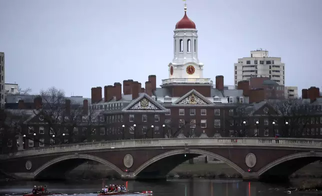 FILE - Rowers paddle down the Charles River near the campus of Harvard University in Cambridge, Mass., March 7, 2017. (AP Photo/Charles Krupa, File)