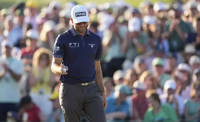 Corey Conners, of Canada, waves after making a putt on the 18th hole during the final round at the Masters golf tournament, Sunday, April 13, 2025, in Augusta, Ga. (AP Photo/Ashley Landis)