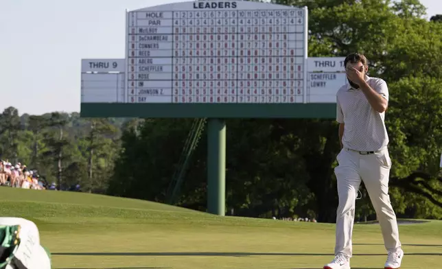 Scottie Scheffler walks off the green on the 18th hole during the final round at the Masters golf tournament, Sunday, April 13, 2025, in Augusta, Ga. (AP Photo/David J. Phillip)