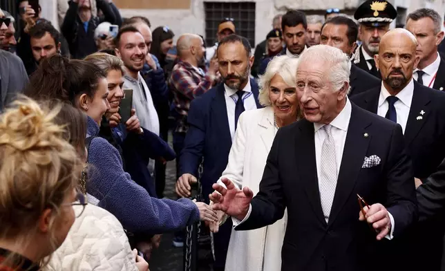 King Charles III and Queen Camilla are greeted outside the Italian Parliament at the end of his address in Rome, Wednesday, April 9, 2025. (Reuters via AP, Pool)