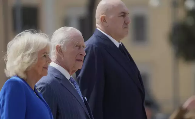 King Charles III, centre, and Queen Camilla pay their homage at the Unknown Soldier's Monument with Italy's Defense ministers Guido Crosetto, right, in Rome, Tuesday, April 8, 2025. (AP Photo/Gregorio Borgia)
