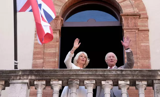 Britain's King Charles III and Queen Camilla wave to well wishers in Ravenna, Italy, Thursday, April 10, 2025. (Massimo Paolone/LaPresse via AP)