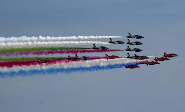 Aerobatic squad aircrafts of the British Red Arrows and the Italian Tricolored Arrows fly over Rome during an official visit to Italy of King Charles III and Queen Camilla, Tuesday, April 8, 2025. (AP Photo/Domenico Stinellis)