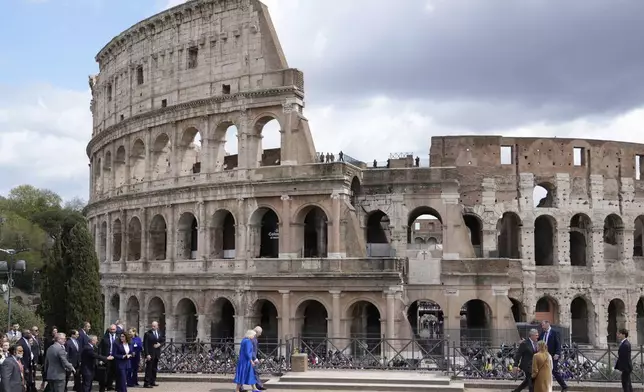 King Charles III, right, and Queen Camilla walk as they visit the Colosseum archeological park, in Rome, Tuesday, April 8, 2025. (AP Photo/Gregorio Borgia)