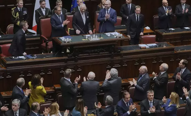 King Charles III, top center, is welcomed by members of the Italian government inside the Italian parliament in Rome, Wednesday, April 9, 2025. (AP Photo/Alessandra Tarantino)