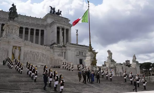 King Charles III, left, and Queen Camilla pay their homage at the Unknown Soldier's Monument, in Rome, Tuesday, April 8, 2025. (AP Photo/Gregorio Borgia)