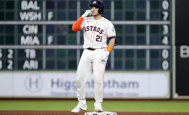 Houston Astros' Yainer Diaz reacts at second base after his one-run RBI double against the Toronto Blue Jays during the sixth inning of a baseball game Tuesday, April 22, 2025, in Houston. (AP Photo/Michael Wyke)
