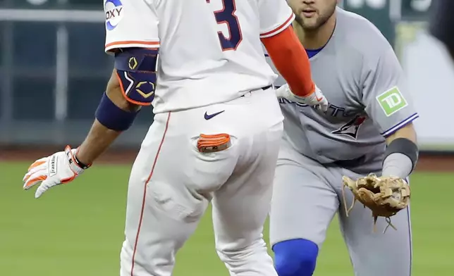 Houston Astros' Jeremy Pena (3) is caught on a run down by Toronto Blue Jays shortstop Bo Bichette, right, during the seventh inning of a baseball game Tuesday, April 22, 2025, in Houston. (AP Photo/Michael Wyke)