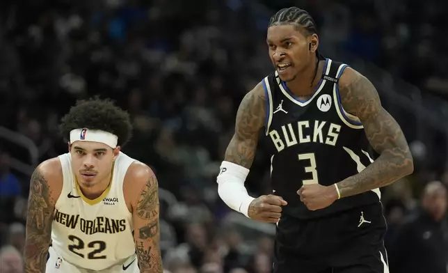 Milwaukee Bucks' Kevin Porter Jr. (3) gestures next to New Orleans Pelicans' Lester Quinones (22) during the second half of an NBA basketball game Thursday, April 10, 2025, in Milwaukee. (AP Photo/Aaron Gash)