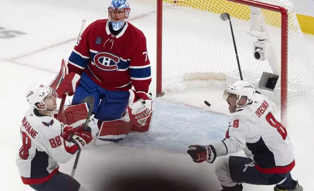 Washington Capitals' Alex Ovechkin (8) celebrates as teammate Andrew Mangiapane (88) scores against Montreal Canadiens goaltender Jakub Dobes (75) during the third period of Game 4 in an NHL hockey first-round playoff series in Montreal, Sunday, April 27, 2025. (Christinne Muschi/The Canadian Press via AP)