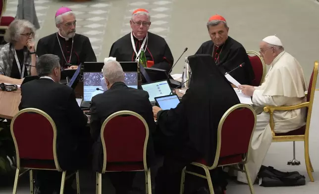 FILE - From left front to camera, Sister Nathalie Becquart, Undersecretary of the Synod of Bishops Luis Marín de San Martín, Synod's Rapporteur Cardinal Jean-Claude Hollerich, and Synod of Bishops' Secretary General Cardinal Mario Grech, listen to Pope Francis, right, during the opening session of the 16th General Assembly of the Synod of Bishops in the Paul VI Hall at The Vatican, Wednesday, Oct. 4, 2023. (AP Photo/Gregorio Borgia, file)