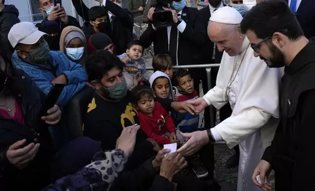FILE - Pope Francis meets migrants during his visit at the Karatepe refugee camp, on the northeastern Aegean island of Lesbos, Greece, Dec. 5, 2021. (AP Photo/Alessandra Tarantino, file)