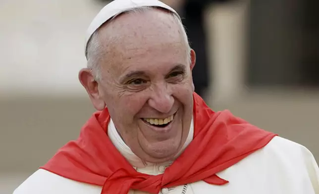 FILE - Pope Francis wears a red scarf as he smiles while leaving St. Peter's Square at the Vatican after an audience with with Altar boys and girls, on Aug. 4, 2015. (AP Photo/Gregorio Borgia, file)
