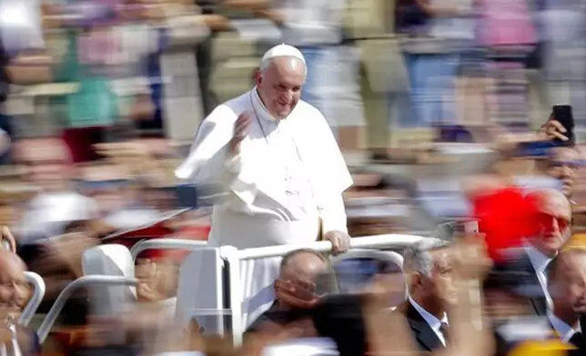 FILE - Pope Francis greets faithful after celebrating Mass on the occasion of the Migrant and Refugee World Day, in St. Peter's Square, at the Vatican, Sunday, Sept. 29, 2019. (AP Photo/Andrew Medichini, file)