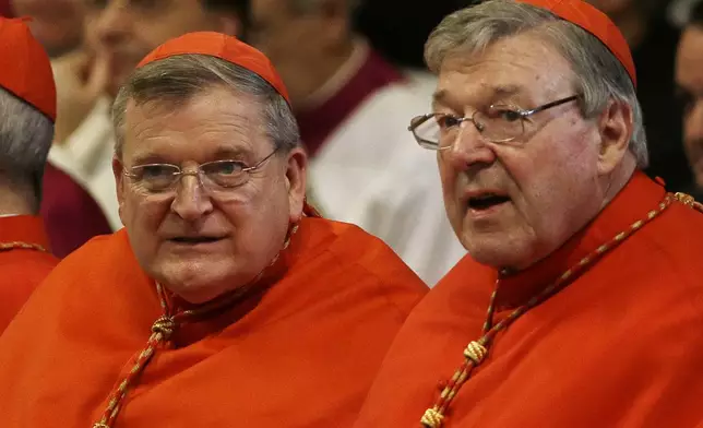 FILE - Cardinal Raymond Leo Burke, left, and Cardinal George Pell wait for the arrival of Pope Francis on the occasion of a Mass where the pontiff bestowed the Pallium, a woolen shawl symbolizing their bond to the pope, to new Metropolitan Archbishops, in St. Peter's Basilica at the Vatican, Monday June 29, 2015. (AP Photo/Gregorio Borgia, file)