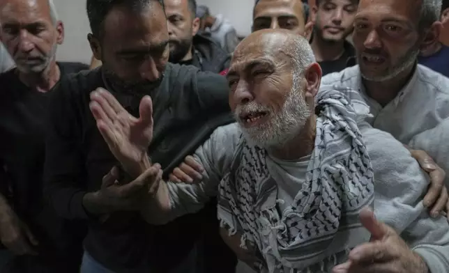 Freed Palestinian prisoner Naeim Al Burai, 66, is welcomed upon arrival at al-Aqsa Hospital in Deir al-Balah, central Gaza Strip, after being released from an Israeli prison, Thursday, April 10, 2025. (AP Photo/Abdel Kareem Hana)