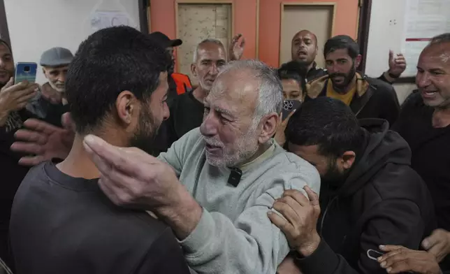Freed Palestinian prisoner Jamal Zuweiri, 69, center, is welcomed upon arrival at al-Aqsa Hospital in Deir al-Balah, central Gaza Strip, after being released from an Israeli prison, Thursday, April 10, 2025. (AP Photo/Abdel Kareem Hana)