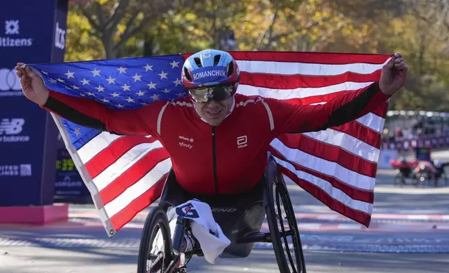 FILE - Daniel Romanchuk poses for photos after winning the men's wheelchair division of the New York City Marathon, Nov. 3, 2024, in New York. (AP Photo/Frank Franklin II, File)