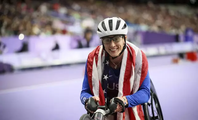 FILE - Tatyana McFadden of the U.S., celebrates before being informed she has been disqualified of the women's 400 m. T54 at the 2024 Paralympics, Sept. 5, 2024, in Paris. (AP Photo/Thomas Padilla, File)