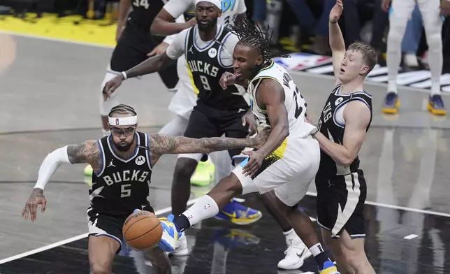 Indiana Pacers' Aaron Nesmith (23) and Milwaukee Bucks' Gary Trent Jr. (5) chase a loose ball as Bucks' AJ Green, right, and Bobby Portis (9) watch during the second half of a first-round NBA basketball playoff game, Saturday, April 19, 2025, in Indianapolis. (AP Photo/Michael Conroy)