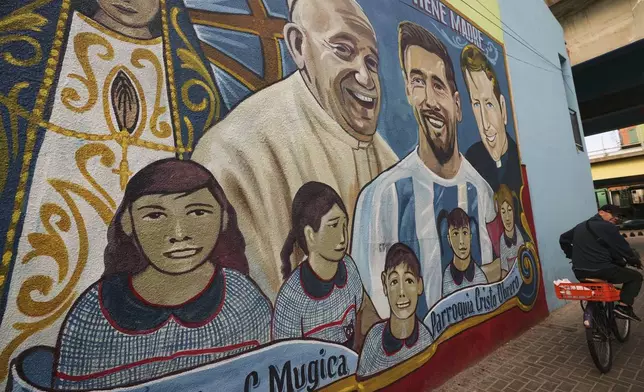 The late Pope Francis is depicted on a mural alongside soccer player Lionel Messi at the Carlos Mugica neighborhood in Buenos Aires, Argentina, Monday, April 21, 2025. (AP Photo/Rodrigo Abd)