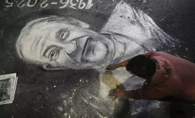 A street artists chalks a portrait of the late Pope Francis outside the Cathedral in Buenos Aires, Argentina Monday, April 21, 2025. (AP Photo/Natacha Pisarenko)