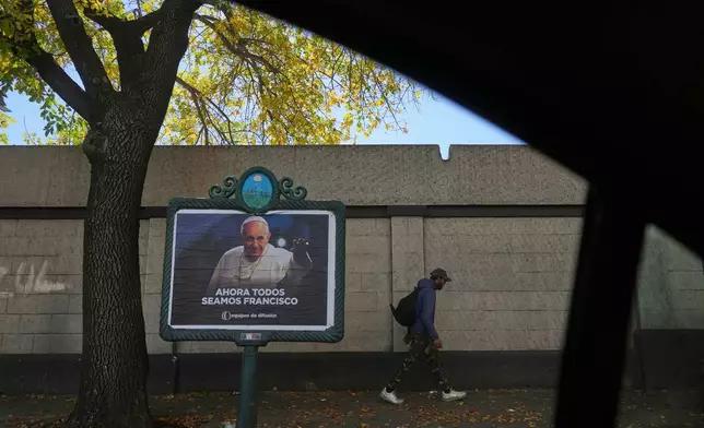 A sign of the late Pope Francis reads in Spanish "Now we're all Francisco" in Buenos Aires, Argentina, Tuesday, April 22, 2025. (AP Photo/Natacha Pisarenko)