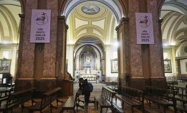 A parishioner prays at the Cathedral following the Vatican's announcement of Pope Francis' death in Buenos Aires, Argentina, Monday, April 21, 2025. (AP Photo/Natacha Pisarenko)