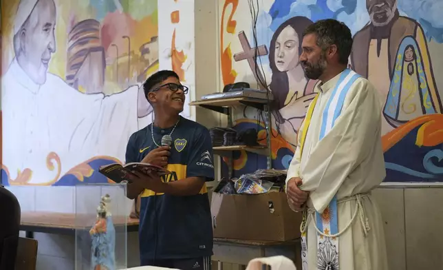 A Gospel reader recites a passage during a Mass for the late Pope Francis at the Hogares de Cristo community center in the Carlos Mugica neighborhood of Buenos Aires, Argentina, part of a network for drug addicts originally supported by then-Archbishop Jorge Bergoglio, Monday, April 21, 2025. (AP Photo/Rodrigo Abd)