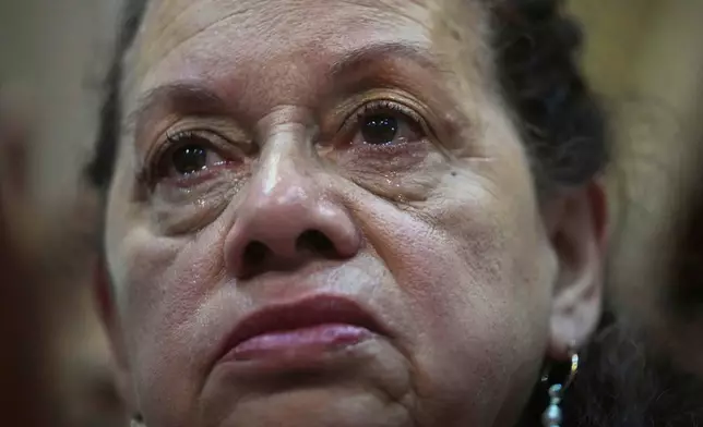 A woman cries during an inter-religious Mass in honor of the late Pope Francis at the Cathedral in Buenos Aires, Argentina, Tuesday, April 22, 2025. (AP Photo/Rodrigo Abd)