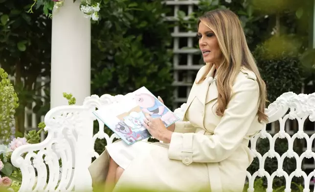 First lady Melania Trump reads a book to children during the White House Easter Egg Roll at the White House, Monday, April 21, 2025, in Washington. (AP Photo/Mark Schiefelbein)